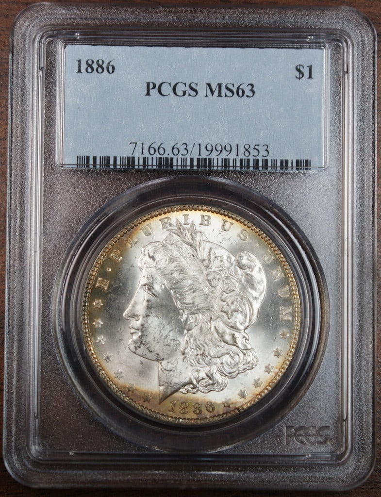 PCGS MS-63 1886 Morgan Dollar Silver Coin With Toning Philadelphia Mint: PCGS MS-63 1886 Morgan Dollar Silver Coin With Toning Philadelphia Mint This is an 1886 Morgan Silver Dollar coin from the Philadelphia Mint, certified by PCGS with a grade of MS-63. The coin is uncir