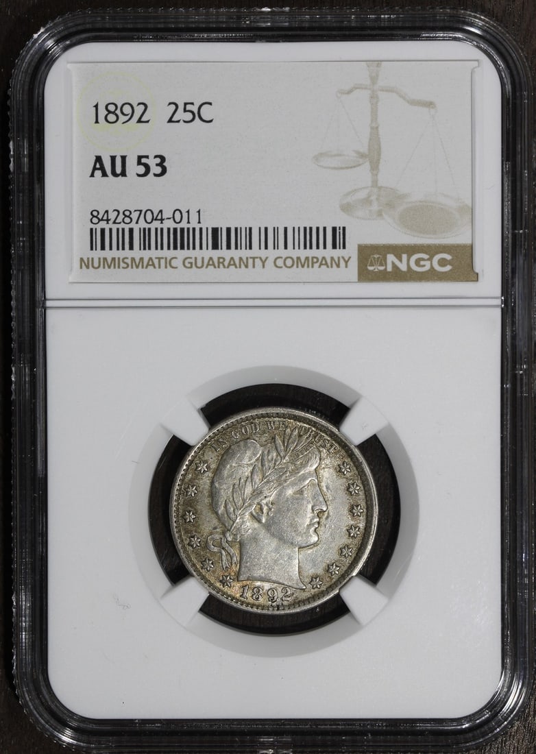 NGC AU53 1892 Barber 25C Silver Quarter: NGC AU53 1892 Barber 25C Silver Quarter This 1892 Barber Quarter is a 25-cent silver coin from the United States, graded AU 53 by NGC. It features the classic Barber design and was minted in Philadelp