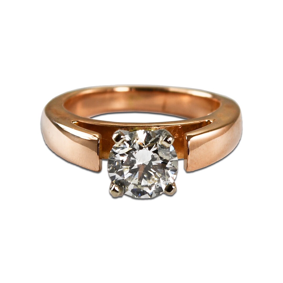 14K Rose Gold Solitaire Ring with 1.03ct Diamond: 14K Rose Gold Solitaire Ring with 1.03ct Diamond This ladies' engagement ring features a 1.03 carat round brilliant cut diamond set in a 14k rose gold solitaire setting. The diamond has a J-K color gr
