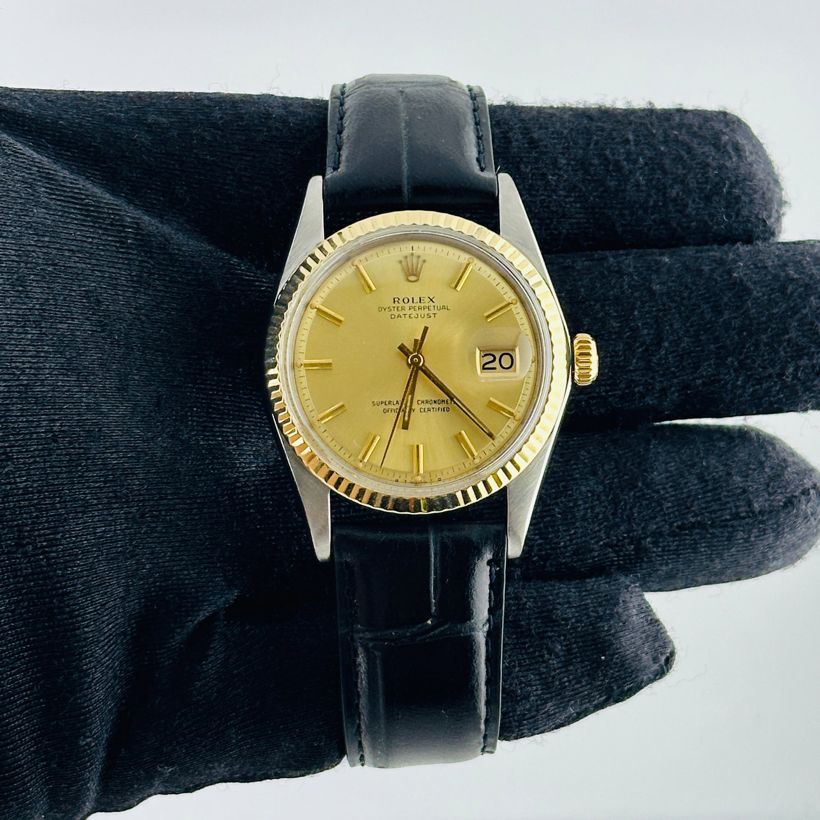 Rolex Datejust 1601 Champagne Stick Dial Leather Band: Rolex Datejust 1601 Champagne Stick Dial Leather Band This Rolex Datejust watch features a champagne stick dial and a fluted bezel, paired with a generic leather band. The reference number for this mo
