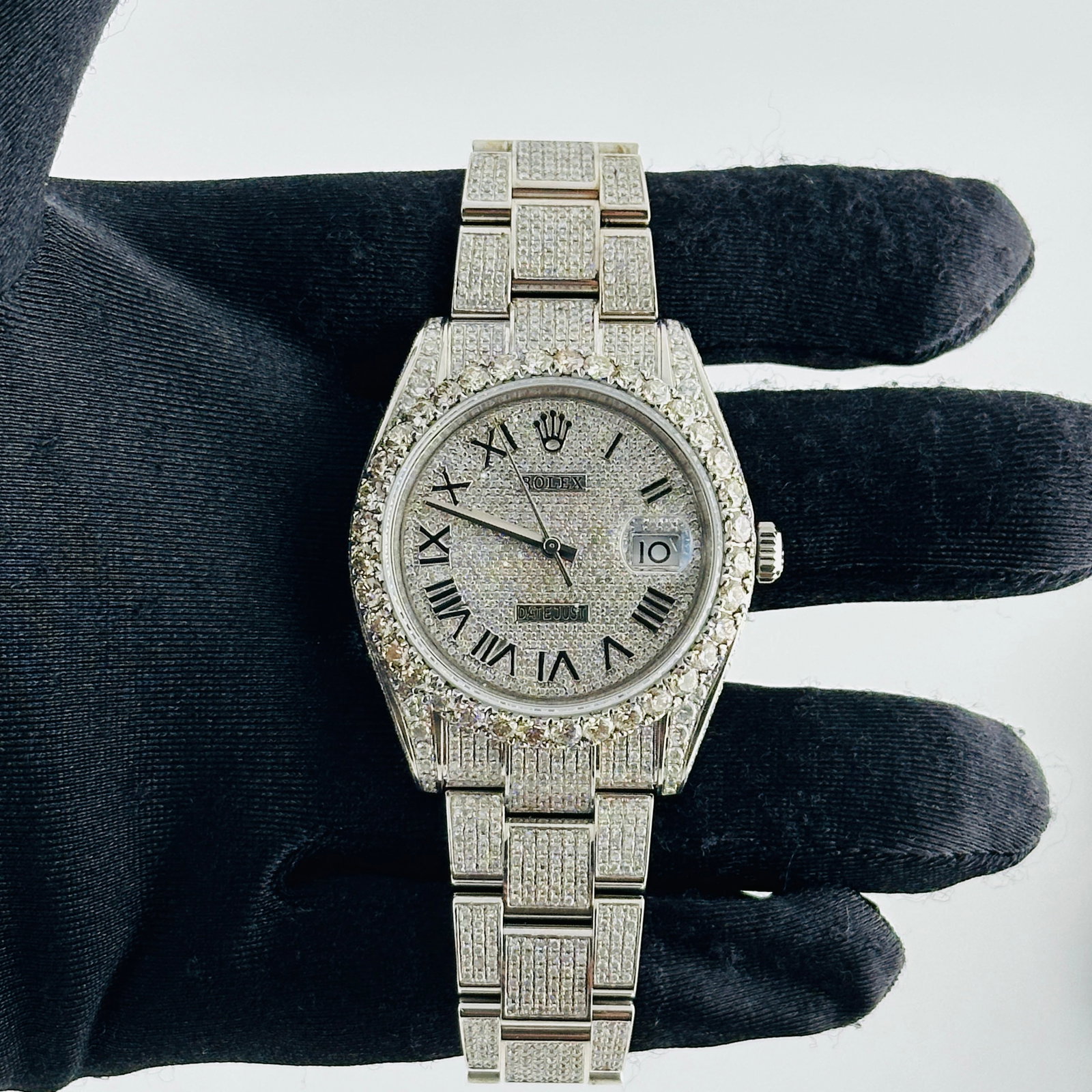 Rolex Datejust 126300 Diamond Roman Dial Aftermarket Diamond Oyster: Rolex Datejust 126300 Diamond Roman Dial Aftermarket Diamond Oyster This men's Rolex Datejust features a Diamond Roman dial and an aftermarket diamond-set Oyster bracelet. The original bezel is set wi