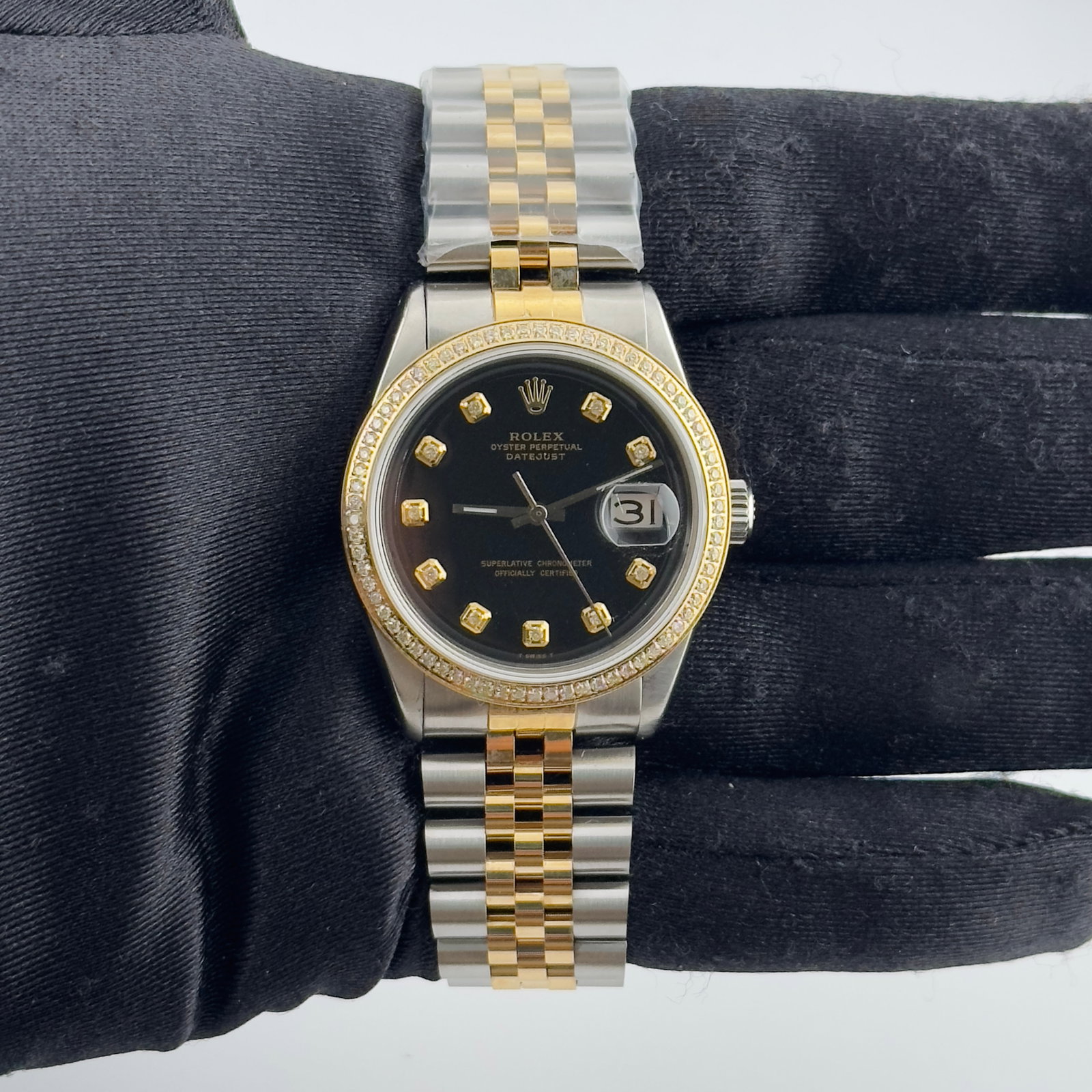 Rolex Datejust aftermarket black diamond dial Jubilee bracelet Ref 1603: Rolex Datejust aftermarket black diamond dial Jubilee bracelet Ref 1603 This men's Rolex Datejust features an aftermarket black diamond dial and a pave plated diamond bezel, enhancing its classic appe