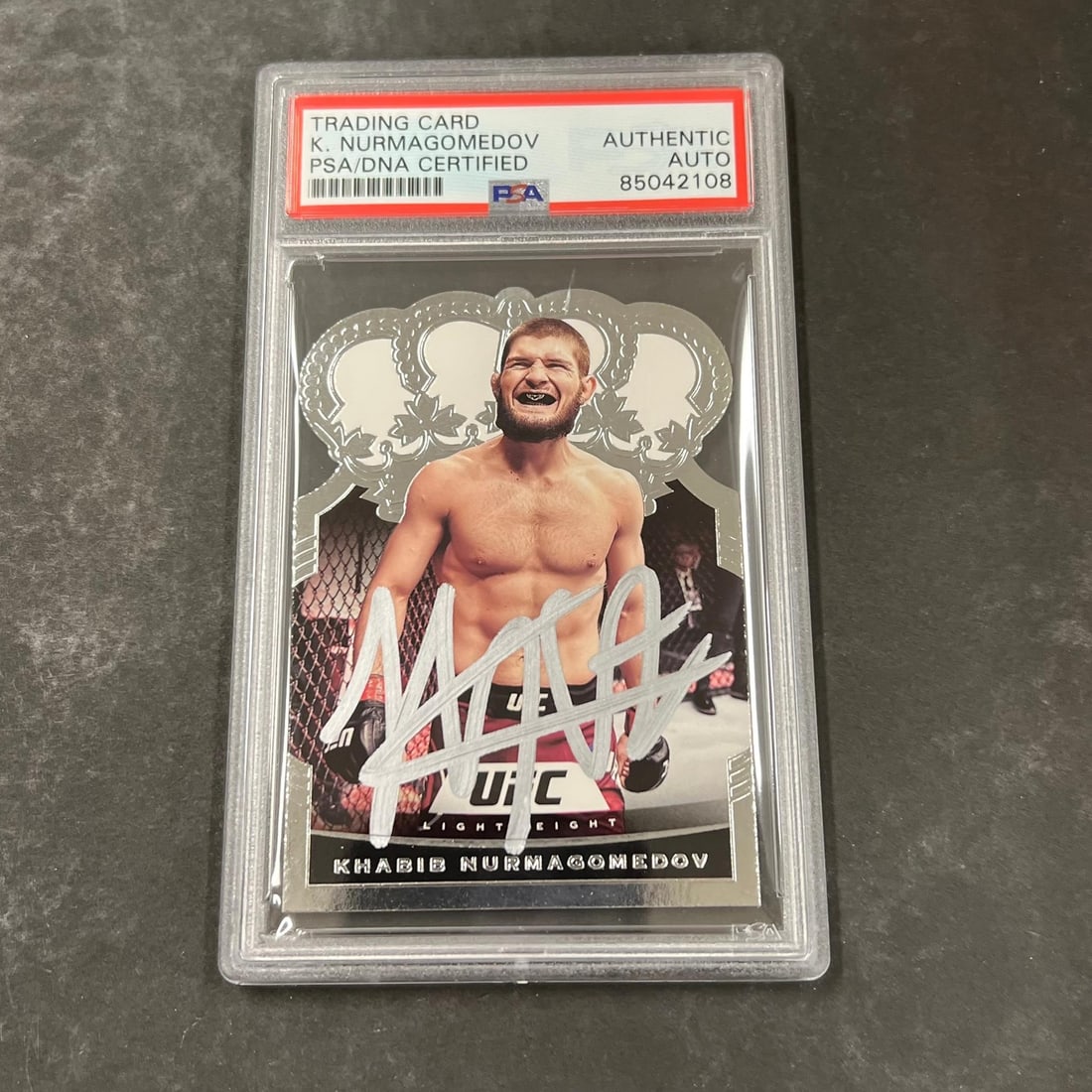 Khabib Nurmagomedov 2021 Panini Chronicles PSA Signed UFC Card #16: Khabib Nurmagomedov 2021 Panini Chronicles PSA Signed UFC Card #16 This 2021 Panini Chronicles #16 sports trading card features Khabib Nurmagomedov and is signed by the athlete. The card is encapsulat