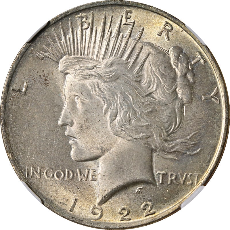 1922 Peace Dollar Silver Coin NGC MS63 With Colorful Toning: 1922 Peace Dollar Silver Coin NGC MS63 With Colorful Toning This 1922-P Peace Dollar is graded MS63 by NGC and features attractive toning. Struck in 90% silver, this uncirculated coin was minted in Ph