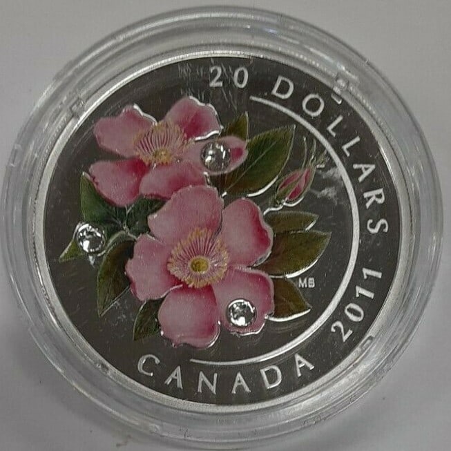 Wild Rose Crystal Series 2011 Canada $20 Silver Proof Coin in Capsule: Wild Rose Crystal Series 2011 Canada $20 Silver Proof Coin in Capsule This 2011 Canada $20 silver coin is part of the Royal Canadian Mint's Crystal Series and features a detailed Wild Rose design