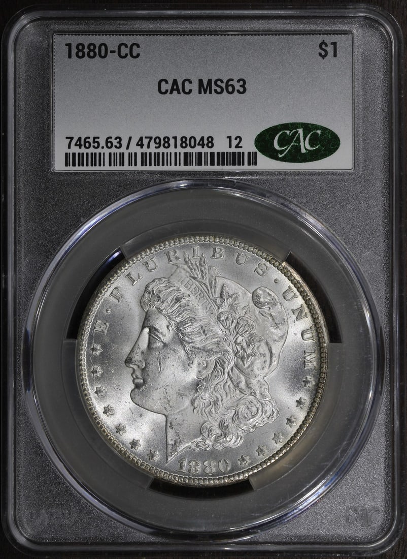 Carson City 1880 Morgan Silver Dollar $1 MS63 CAC CACG: Carson City 1880 Morgan Silver Dollar $1 MS63 CAC CACG 1880-CC Morgan Silver Dollar graded MS63 with CAC approval. The coin is a pre-owned United States issue with a silver composition and Carson City
