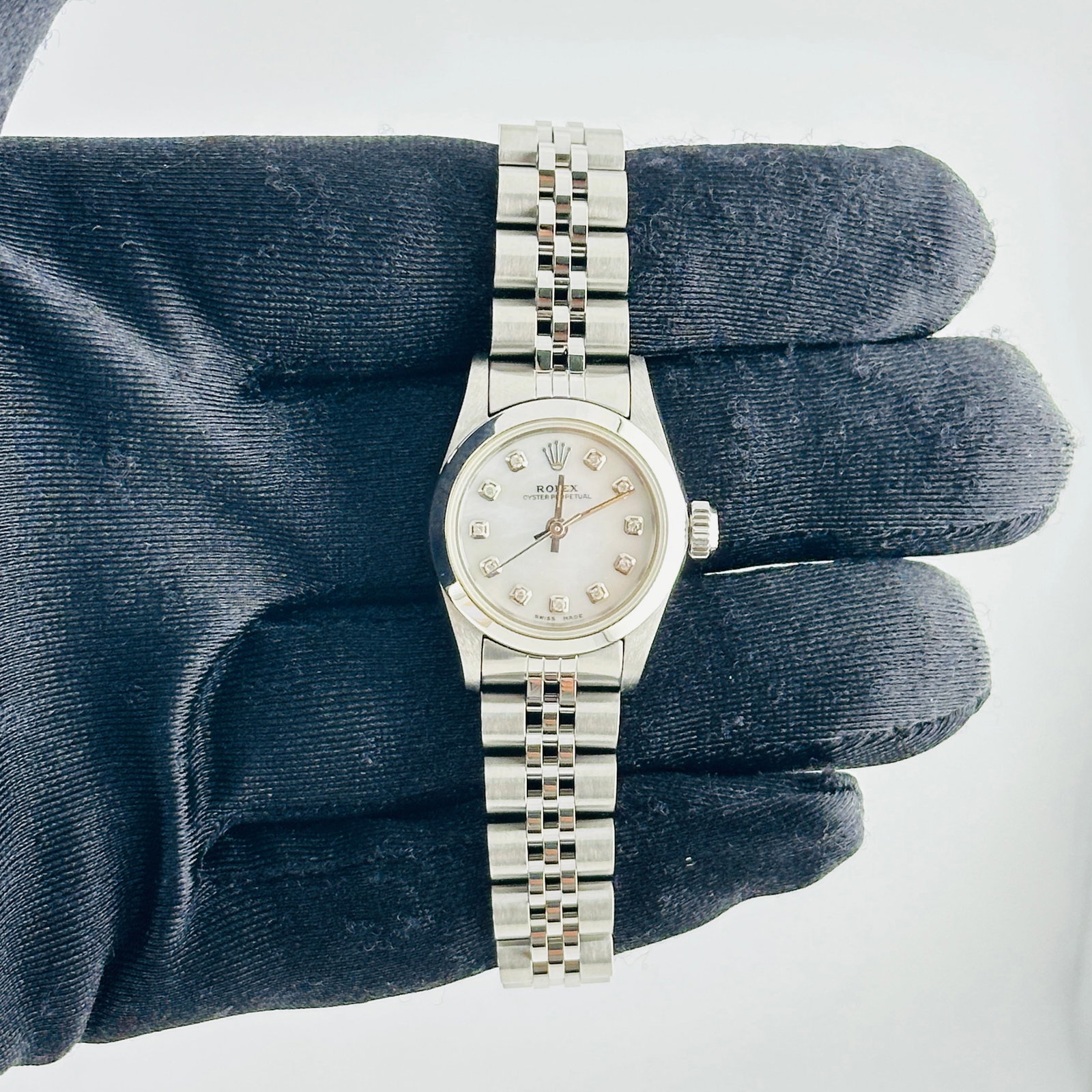 Rolex Oyster Perpetual Ladies White MOP Diamond Dial Jubilee Bracelet Ref 67180: Rolex Oyster Perpetual Ladies White MOP Diamond Dial Jubilee Bracelet Ref 67180 This ladies Rolex Oyster Perpetual features an aftermarket white mother-of-pearl dial set with diamond hour markers. The