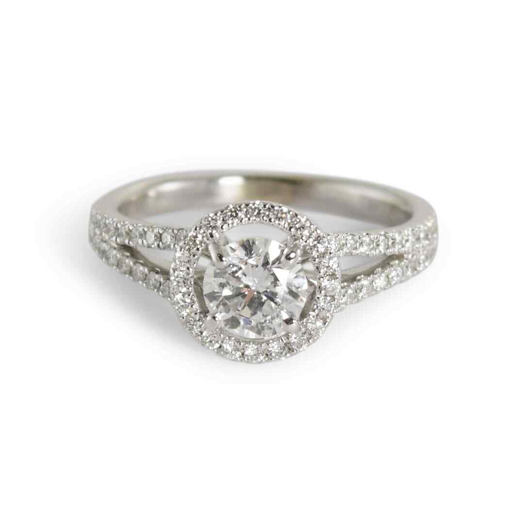GIA Certified 14K White Gold Round Brilliant Halo Ring Size 6: GIA Certified 14K White Gold Round Brilliant Halo Ring Size 6 This 14K white gold diamond halo ring features a GIA certified round brilliant center diamond weighing 0.67 carats, with E color and I1 cl