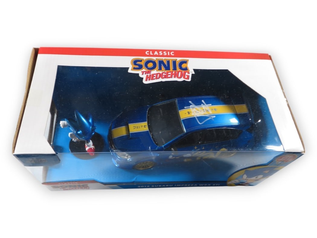 Ben Schwartz Signed Sonic the Hedgehog Die-Cast Car JSA Authenticated: Ben Schwartz Signed Sonic the Hedgehog Die-Cast Car JSA Authenticated This is an authentic die-cast car autographed by Ben Schwartz, the voice of Sonic the Hedgehog. The signature has been verified by