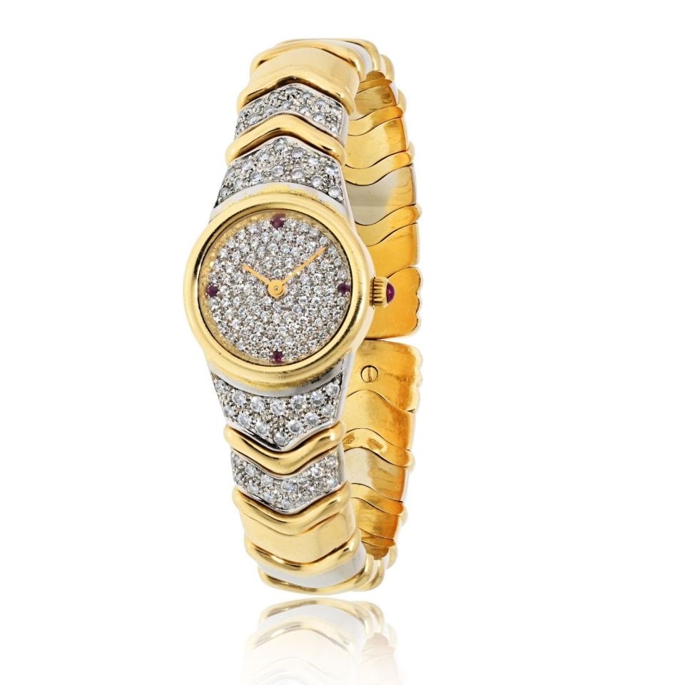 Bvlgari Parentisi 18K Two Tone Diamond Ruby Vintage Watch: Bvlgari Parentisi 18K Two Tone Diamond Ruby Vintage Watch This exquisite vintage Bvlgari Parentisi watch is a stunning timepiece crafted in 18K two-tone gold, featuring both yellow and white gold. The