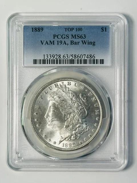 PCGS MS-63 1889 Morgan Silver Dollar VAM 19A Bar Wing: PCGS MS-63 1889 Morgan Silver Dollar VAM 19A Bar Wing 1889 Morgan Silver Dollar certified by PCGS with an MS 63 grade. This Philadelphia-minted USA coin is identified as VAM 19A, Bar Wing, and is list