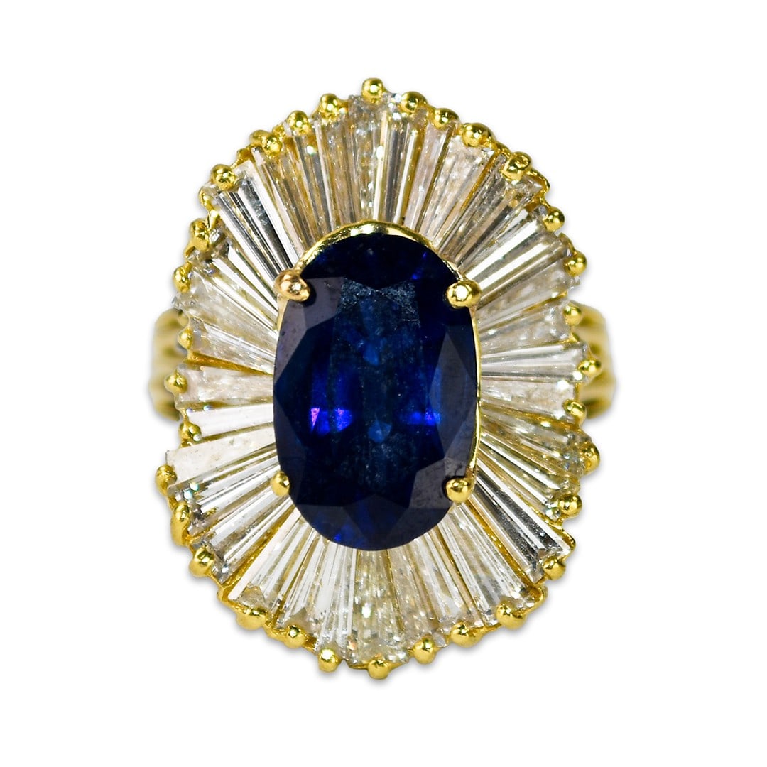 Oval Sapphire Diamond Cocktail Ring 18K Yellow Gold Size 8.75: Oval Sapphire Diamond Cocktail Ring 18K Yellow Gold Size 8.75 This elegant cocktail ring features a deep blue, oval-shaped lab-grown sapphire weighing 7.00 carats, set in 18k yellow gold. The ring is 