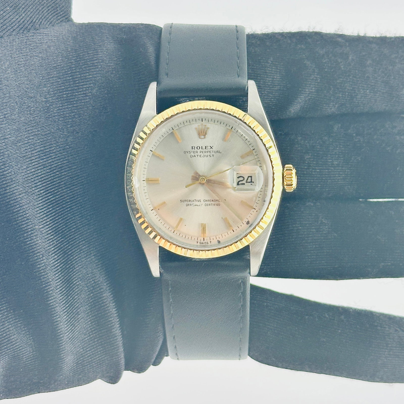 Rolex Datejust 1601 3 Silver Gold Stick Dial Leather Band: Rolex Datejust 1601 3 Silver Gold Stick Dial Leather Band This Rolex Datejust features a silver and gold stick dial, complemented by a fluted bezel. The watch comes with a generic leather band, offeri
