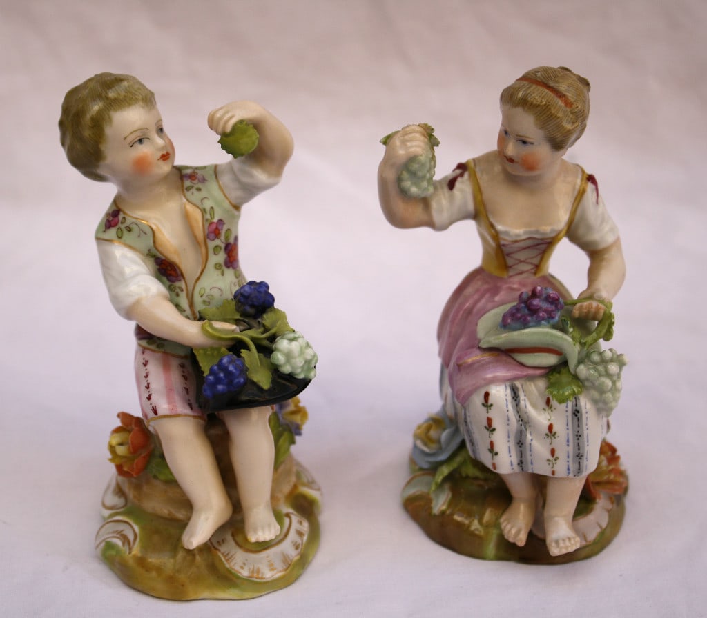 19th Century Signed German Porcelain Boy Girl Figurines TX 490 138: 19th Century Signed German Porcelain Boy Girl Figurines TX 490 138 This exquisite pair of 19th-century German porcelain figurines, crafted between 1850 and 1900, showcases a charming boy and girl hold