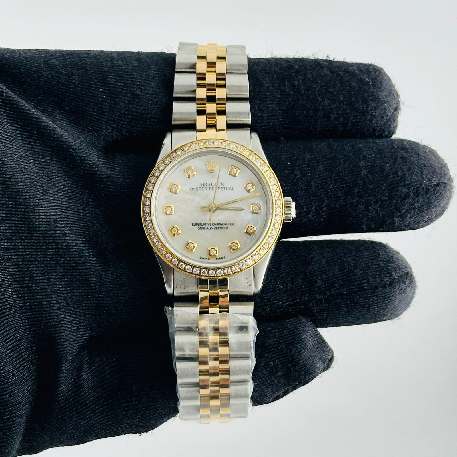 Rolex Oyster Perpetual Ladies Aftermarket Jubilee Bracelet Ref 6466: Rolex Oyster Perpetual Ladies Aftermarket Jubilee Bracelet Ref 6466 This ladies Rolex Oyster Perpetual features an aftermarket white mother-of-pearl dial with yellow diamond markers, complemented by a