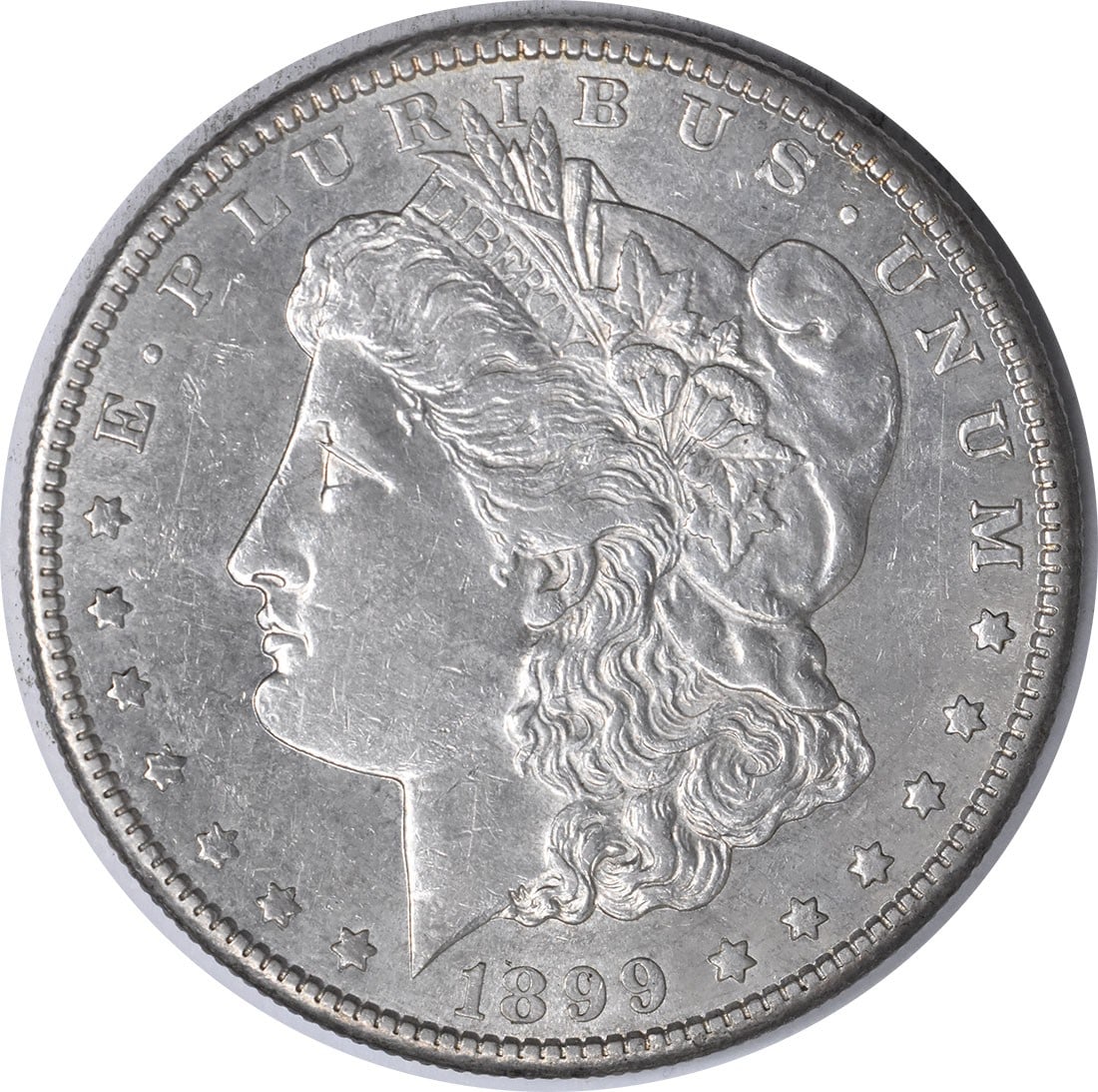 1899-S Morgan Silver Dollar AU Uncertified Coin by George T. Morgan: 1899-S Morgan Silver Dollar AU Uncertified Coin by George T. Morgan This 1899-S Morgan Silver Dollar is an exquisite piece for collectors, showcasing a grade of AU (Almost Uncirculated). Minted in San