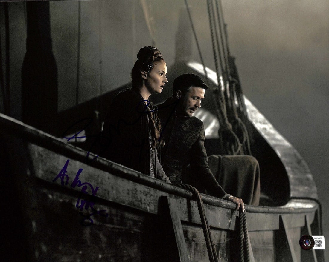 Game of Thrones 11x14 Photo Signed by Aiden Gillen and Sophie Turner Beckett Authenticated: Game of Thrones 11x14 Photo Signed by Aiden Gillen and Sophie Turner Beckett Authenticated This is an original 11x14-inch photograph from Game of Thrones, autographed in blue permanent marker by Aiden