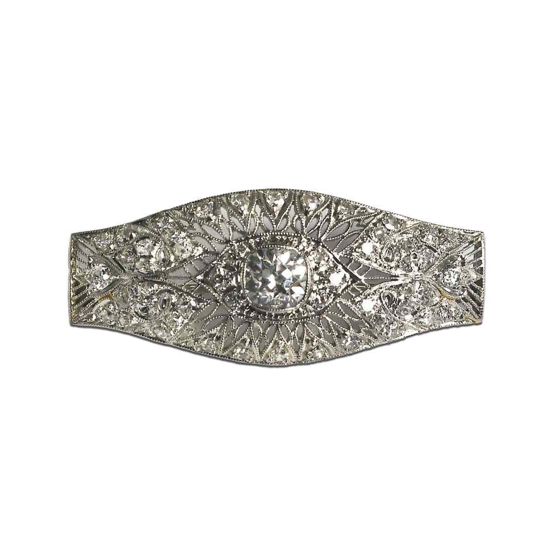 Platinum Diamond Pendant Brooch 1.24 ct Antique: Platinum Diamond Pendant Brooch 1.24 ct Antique This antique brooch features a stunning combination of platinum and diamonds, crafted with intricate open-metal work. The centerpiece is an antique cush