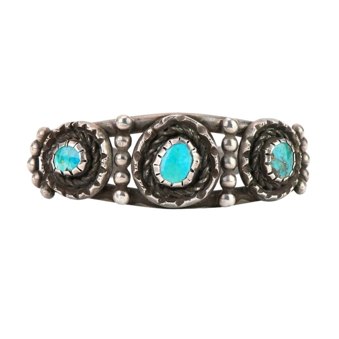 Native American Sterling Silver Turquoise Cuff Bracelet 1.275 ozt: Native American Sterling Silver Turquoise Cuff Bracelet 1.275 ozt This antique Native American sterling silver cuff bracelet showcases three genuine turquoise stones in oval and circular shapes, set i