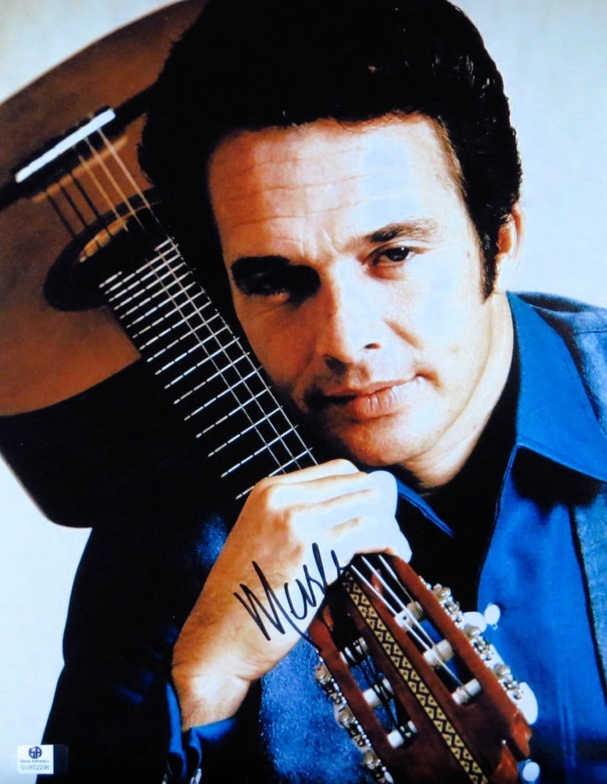 Autographed 11x14 Merle Haggard Photo with Guitar GAI Authenticated: Autographed 11x14 Merle Haggard Photo with Guitar GAI Authenticated This 11x14 photo features the legendary Merle Haggard with his guitar and is hand-signed by the artist. The autograph is authenticat