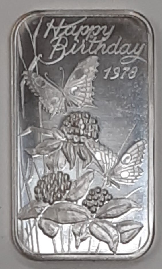 Happy Birthday 1978 One Troy Ounce Silver Bar by Madison Mint: Happy Birthday 1978 One Troy Ounce Silver Bar by Madison Mint This is a Madison Mint 1 Troy Ounce silver bar featuring a 'Happy Birthday 1978' design with butterflies and flowers. Made of .999 fine si