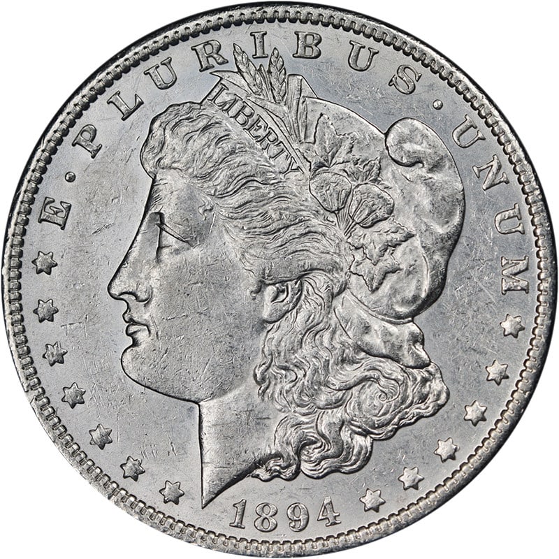 1894 O Morgan Silver Dollar Key Date AU BU: 1894 O Morgan Silver Dollar Key Date AU BU This 1894-O Morgan Silver Dollar is a key date coin featuring attractive eye appeal, strong luster, and a well-defined strike. The coin displays bright white