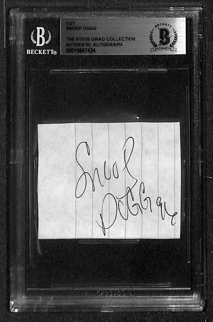 Snoop Dogg Signed Cut 1996 Beckett Authenticated Autograph: Snoop Dogg Signed Cut 1996 Beckett Authenticated Autograph This is an original autographed cut signed by the iconic rapper Snoop Dogg, authenticated by Beckett Authentication Services. The signature i