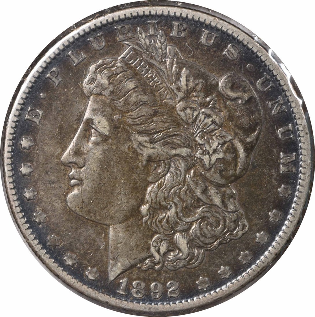 1892-O Morgan Silver Dollar VAM 5 Uncertified 90% Silver Coin: 1892-O Morgan Silver Dollar VAM 5 Uncertified 90% Silver Coin This 1892-O VAM 5 (7) Morgan Silver Dollar showcases the iconic design by George T. Morgan, featuring the renowned doubled ear detail. Str
