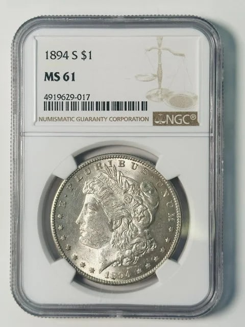 1894-S Morgan Dollar NGC MS61 White: 1894-S Morgan Dollar NGC MS61 White This 1894 Morgan Silver Dollar was minted in San Francisco and is graded MS-61 by NGC. Composed of silver, this pre-owned coin is a collectible piece from the USA, 