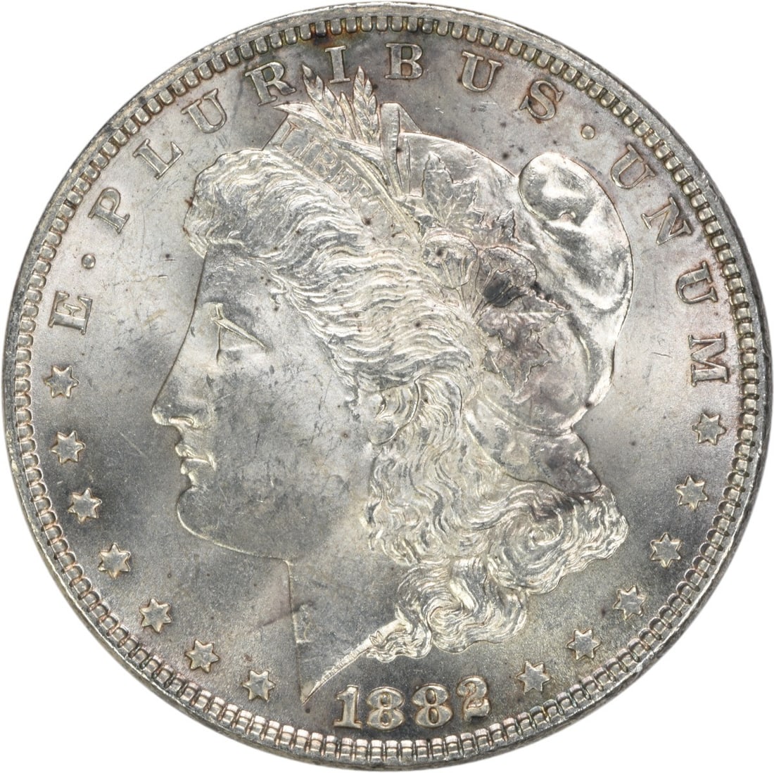 Uncirculated 1882 Morgan Dollar Silver Coin With Attractive Toning: Uncirculated 1882 Morgan Dollar Silver Coin With Attractive Toning This 1882 Morgan Silver Dollar is a choice brilliant uncirculated coin featuring attractive toning. The coin is uncertified and has n