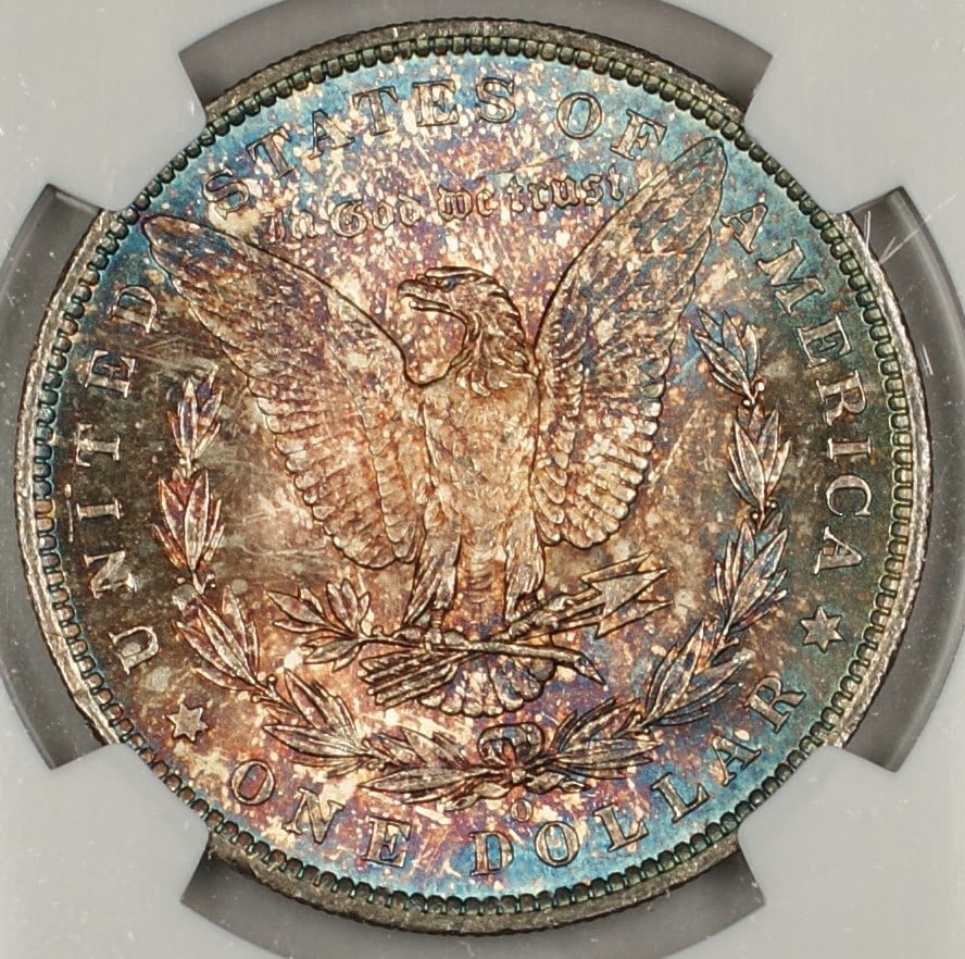 NGC MS63 1885-O Morgan Silver Dollar with Attractive Reverse Toning: NGC MS63 1885-O Morgan Silver Dollar with Attractive Reverse Toning This 1885-O Morgan Silver Dollar is certified by NGC with a grade of MS 63. The coin is uncirculated and features beautiful toning, 