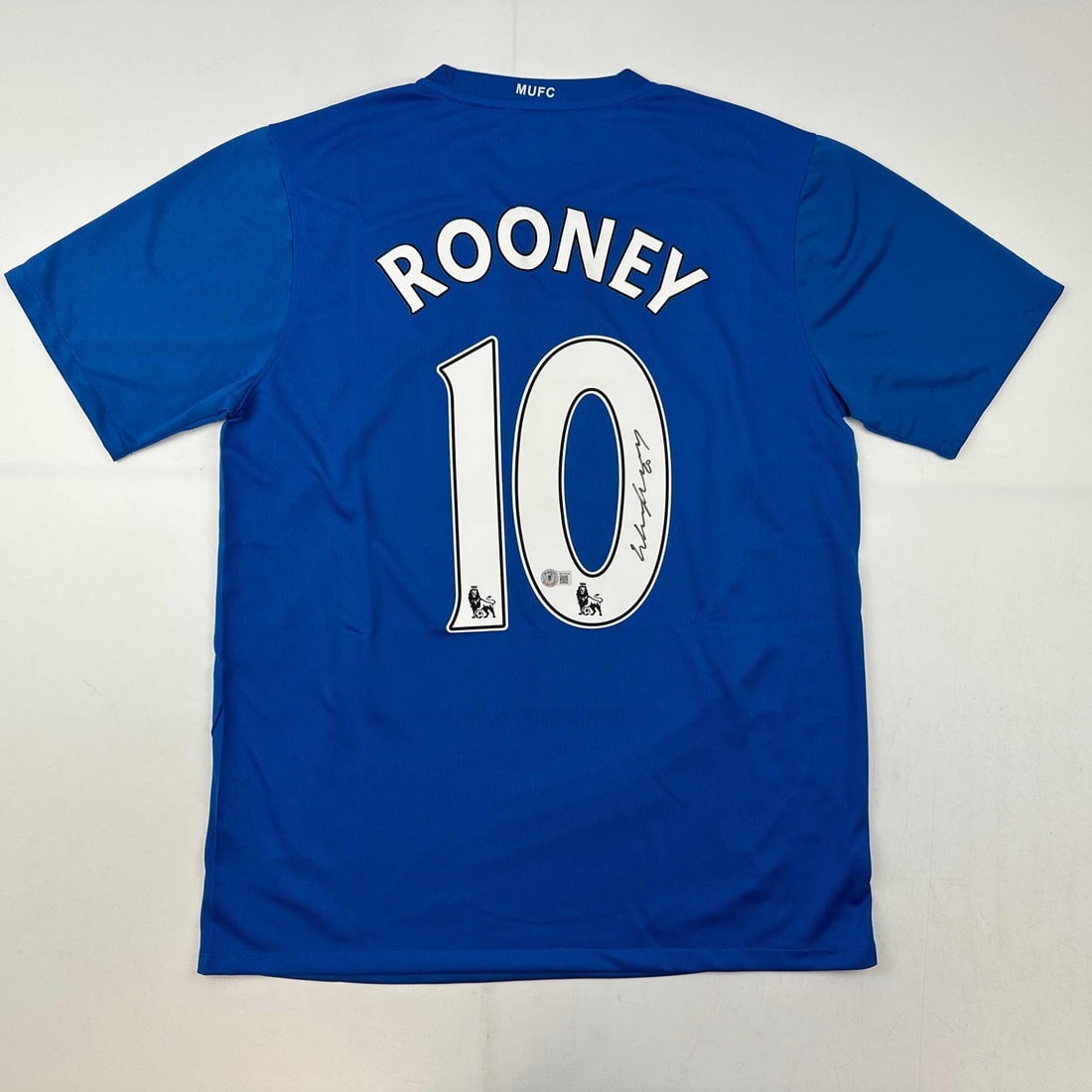 Wayne Rooney Autographed Manchester United Blue Jersey Beckett BAS COA: Wayne Rooney Autographed Manchester United Blue Jersey Beckett BAS COA This is an authentic autographed Wayne Rooney Manchester United blue jersey, featuring the signature of the iconic player himself