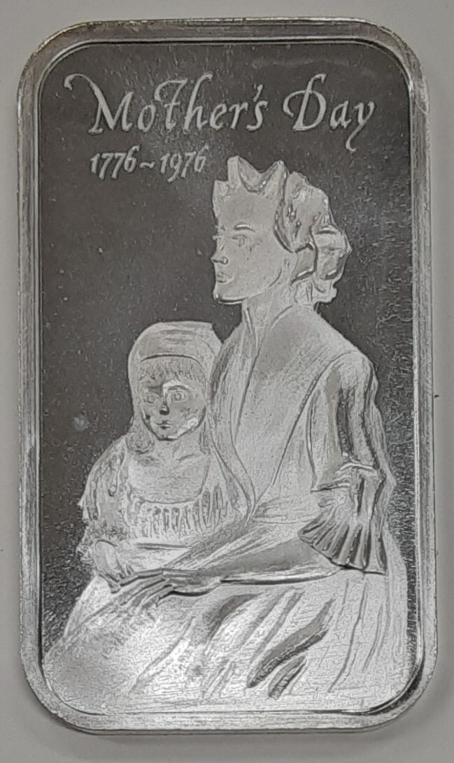 1976 Mother's Day 1 Troy Oz Silver Bar Madison Mint .999 Fine: 1976 Mother's Day 1 Troy Oz Silver Bar Madison Mint .999 Fine This Madison Mint silver bar commemorates Mother's Day 1976 with a depiction of a mother and her child. Crafted in the United States, the 