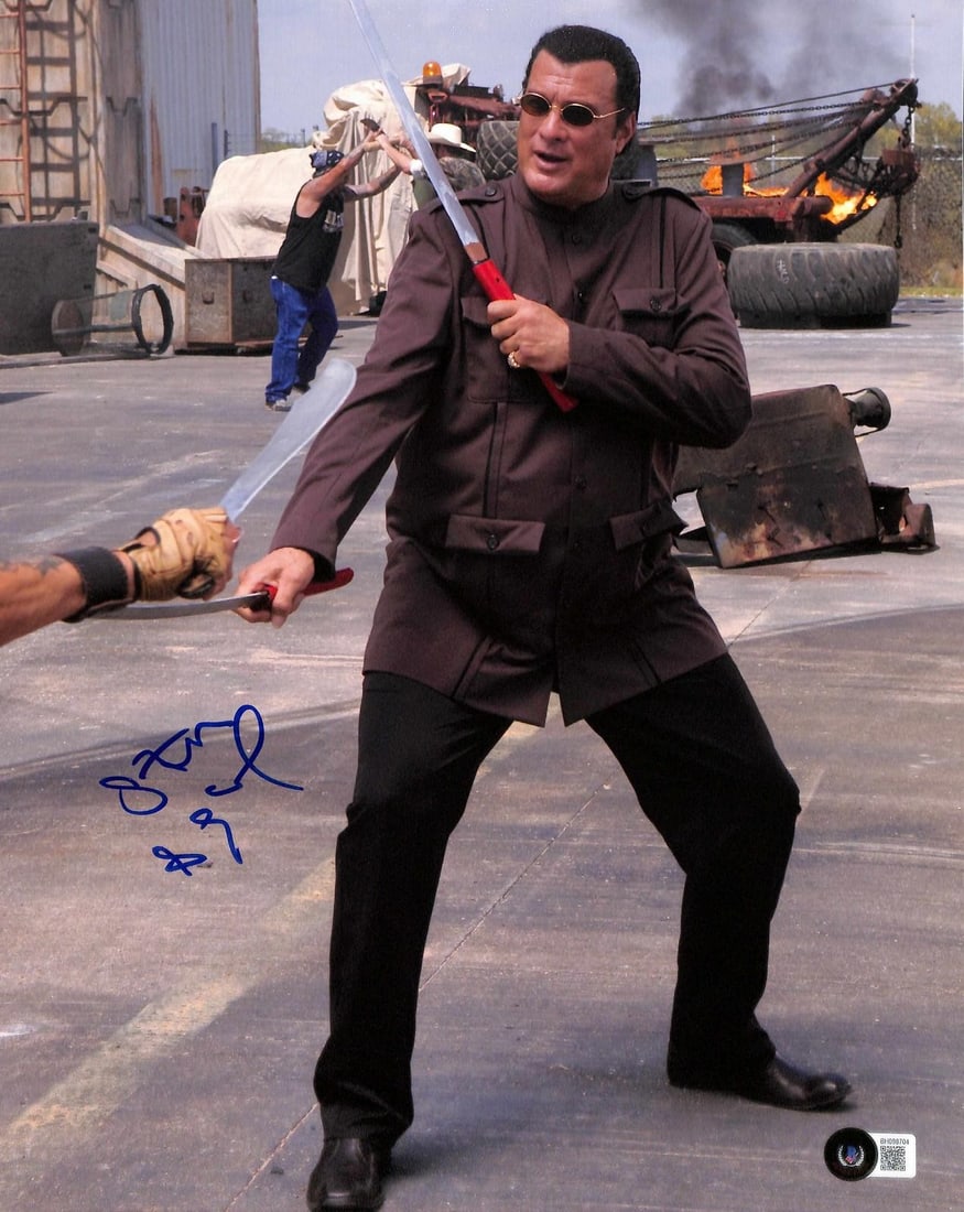 11x14 Steven Seagal autographed action photo Beckett certified: 11x14 Steven Seagal autographed action photo Beckett certified This 11x14 color action photograph features martial artist and film star Steven Seagal in a dynamic sword-fighting scene. The photo is ha