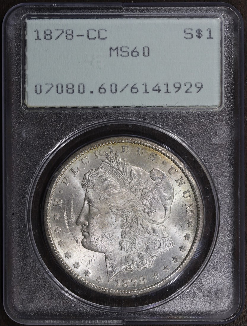 PCGS Rattler 1878 CC Morgan Silver Dollar MS60: PCGS Rattler 1878 CC Morgan Silver Dollar MS60 This is an 1878 Morgan Silver Dollar minted in Carson City, graded MS60 by PCGS and housed in an OGH Rattler holder. The coin is uncirculated and compose