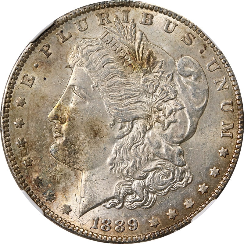 1889 P Morgan Dollar NGC MS63 Silver Toned: 1889 P Morgan Dollar NGC MS63 Silver Toned This 1889 Morgan Silver Dollar has been graded MS63 by NGC and features attractive toning. Struck at the Philadelphia Mint, this uncirculated coin is compose