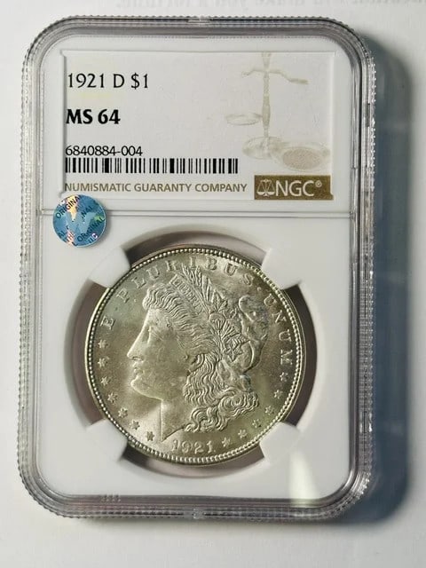 1921 Denver Morgan Dollar NGC MS64 Sight White: 1921 Denver Morgan Dollar NGC MS64 Sight White This 1921 Morgan Silver Dollar was minted in Denver and has been certified by NGC with a grade of MS 64. Composed of silver, this pre-owned coin offers a