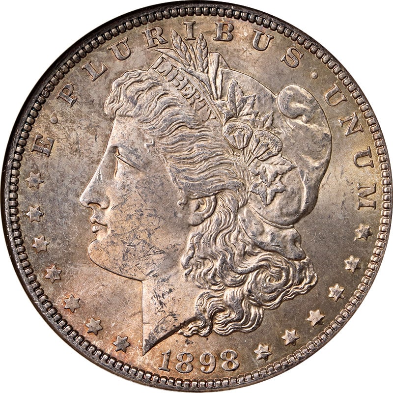 NGC MS63 1898 Morgan Dollar from Philadelphia with Toned Surfaces: NGC MS63 1898 Morgan Dollar from Philadelphia with Toned Surfaces This 1898-P Morgan Silver Dollar is graded MS63 by NGC and features attractive toning. Struck at the Philadelphia Mint, this uncircula