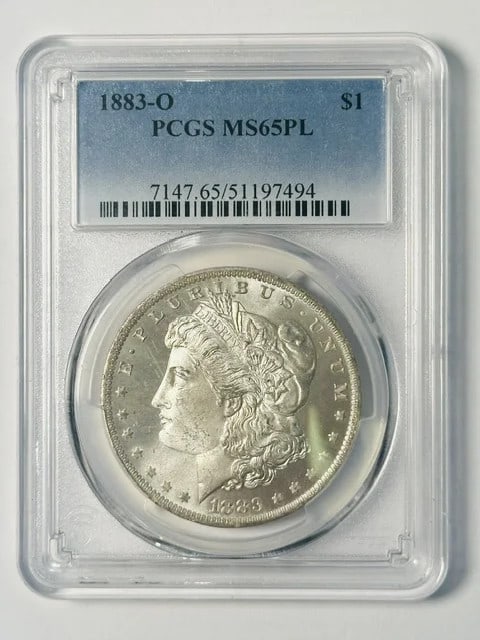PCGS MS65 PL 1883 O Morgan Silver Dollar White: PCGS MS65 PL 1883 O Morgan Silver Dollar White 1883-O Morgan Silver Dollar certified by PCGS and graded MS 65 PL. This pre-owned silver dollar was minted in New Orleans and has a proof-like appearance