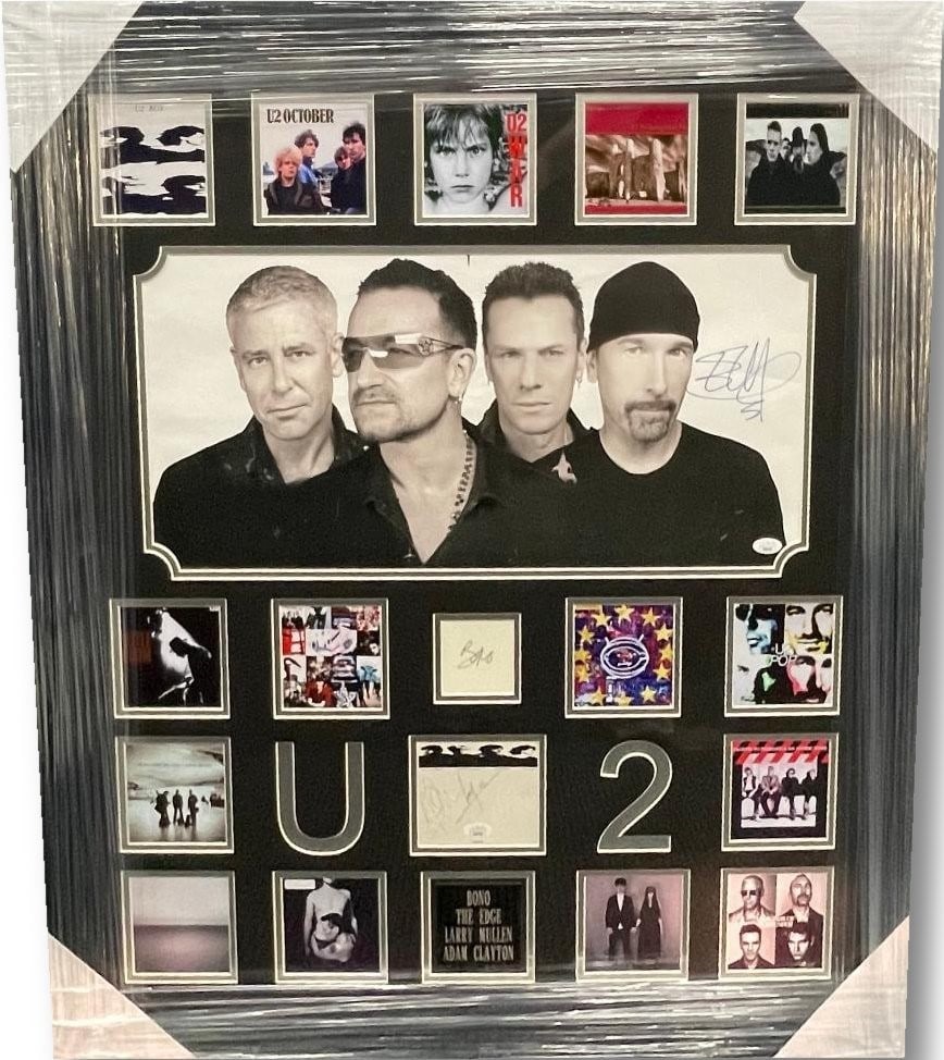 U2 Band Signed 31x35 Framed Photo with JSA Certificate Autographs: U2 Band Signed 31x35 Framed Photo with JSA Certificate Autographs This is an original autographed photograph featuring all four members of the U2 band: Bono (Paul Hewson), Adam Clayton, David Evans, a