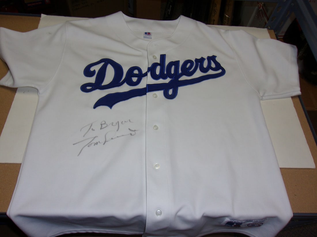 Russell Dodgers Jersey Signed by Tom Lasorda with COA World Series Champion: Russell Dodgers Jersey Signed by Tom Lasorda with COA World Series Champion This is an official licensed Russell jersey, signed by Tom Lasorda, commemorating the Dodgers' 1981 and 1988 World Series ch