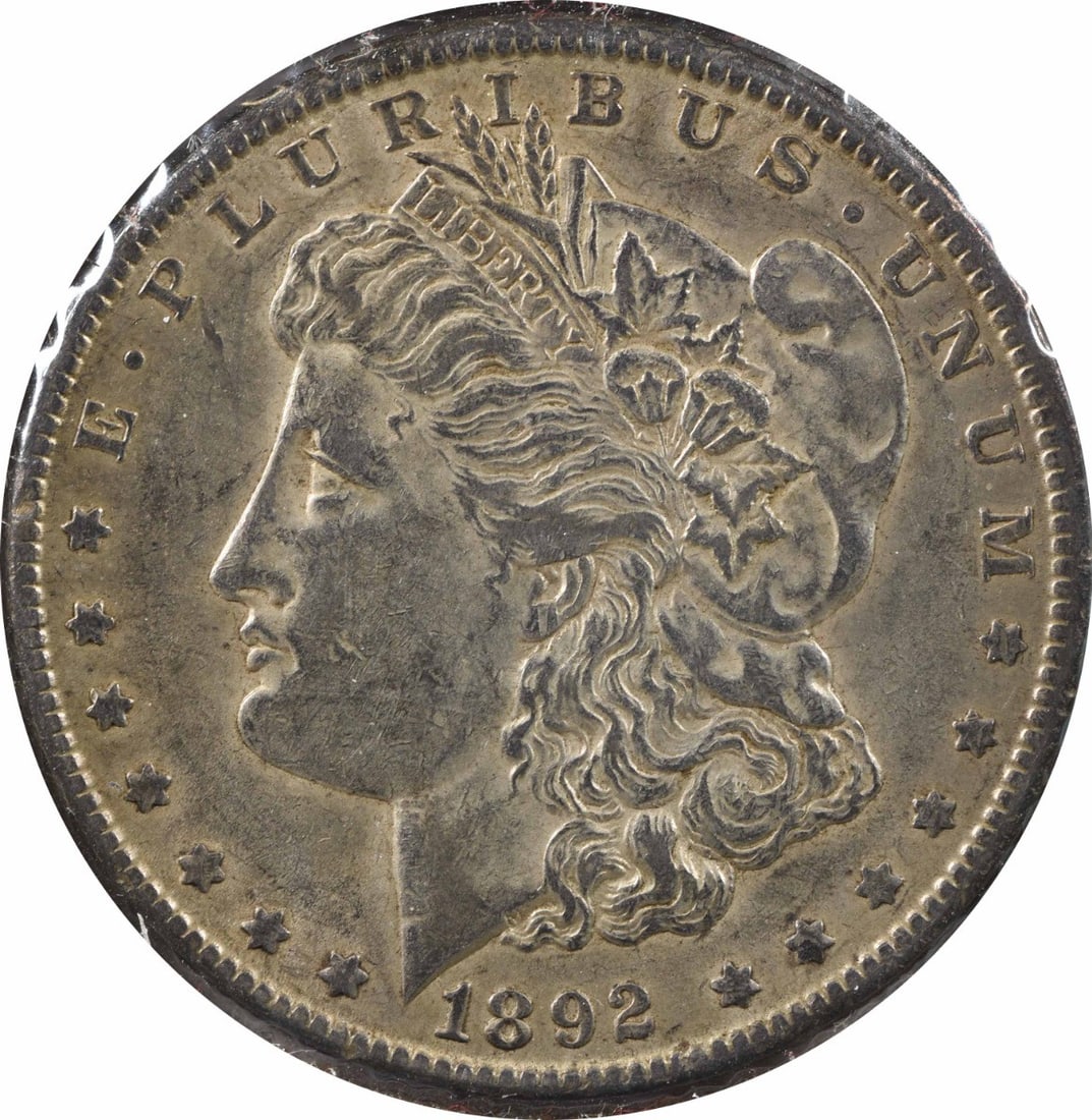 1892-O Morgan Silver Dollar VAM 5(7) AU Uncertified Coin by George T. Morgan: 1892-O Morgan Silver Dollar VAM 5(7) AU Uncertified Coin by George T. Morgan This 1892-O VAM 5(7) Morgan Silver Dollar is a stunning piece from the New Orleans Mint, showcasing the renowned craftsmans
