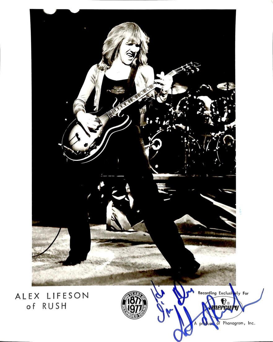 Alex Lifeson 1977 Vintage Signed Rush Photo Beckett LOA: Alex Lifeson 1977 Vintage Signed Rush Photo Beckett LOA This remarkable vintage 1977 photograph features the signature of Alex Lifeson, the legendary guitarist of Rush. Inscribed in blue ink with the 