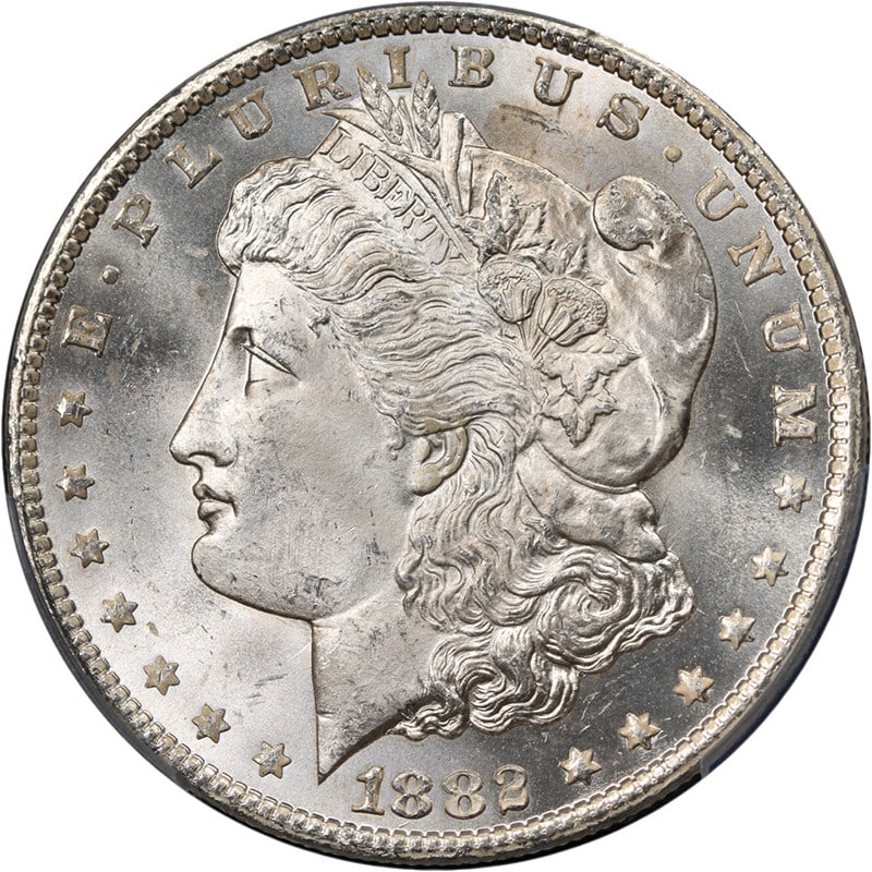 PCGS MS64 1882-CC Morgan Silver Dollar Blast White: PCGS MS64 1882-CC Morgan Silver Dollar Blast White An original 1882-CC Morgan Silver Dollar certified by PCGS and graded MS64. The coin is described as blast white with great eye appeal, fantastic lus