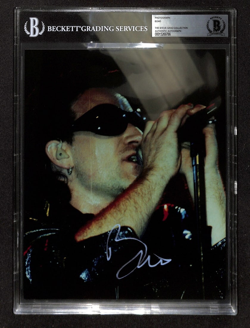 Bono U2 Signed 8X10 Photo Beckett Authenticated: Bono U2 Signed 8X10 Photo Beckett Authenticated This is an original autographed 8x10 photograph of Bono, the iconic frontman of U2, signed in silver permanent marker. The signature has been authentica