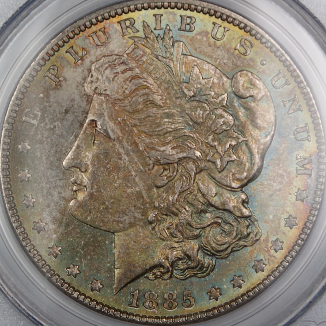 PCGS MS-63 1885 Philadelphia Morgan Dollar Silver Coin with Attractive Toning: PCGS MS-63 1885 Philadelphia Morgan Dollar Silver Coin with Attractive Toning This 1885 Morgan Silver Dollar was struck in Philadelphia and is certified by PCGS with a grade of MS-63. Composed of silv