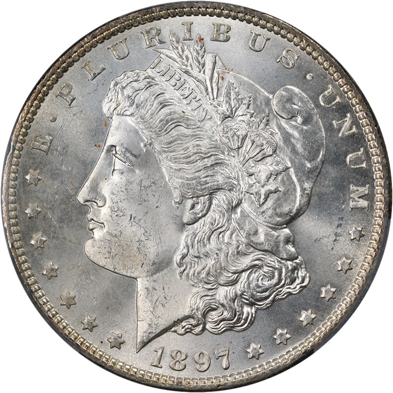 PCGS MS63 1897 P Morgan Silver Dollar Blast White: PCGS MS63 1897 P Morgan Silver Dollar Blast White This is an original 1897-P Morgan Silver Dollar graded MS63 by PCGS. The coin is uncirculated, features a strong strike, and displays excellent luster