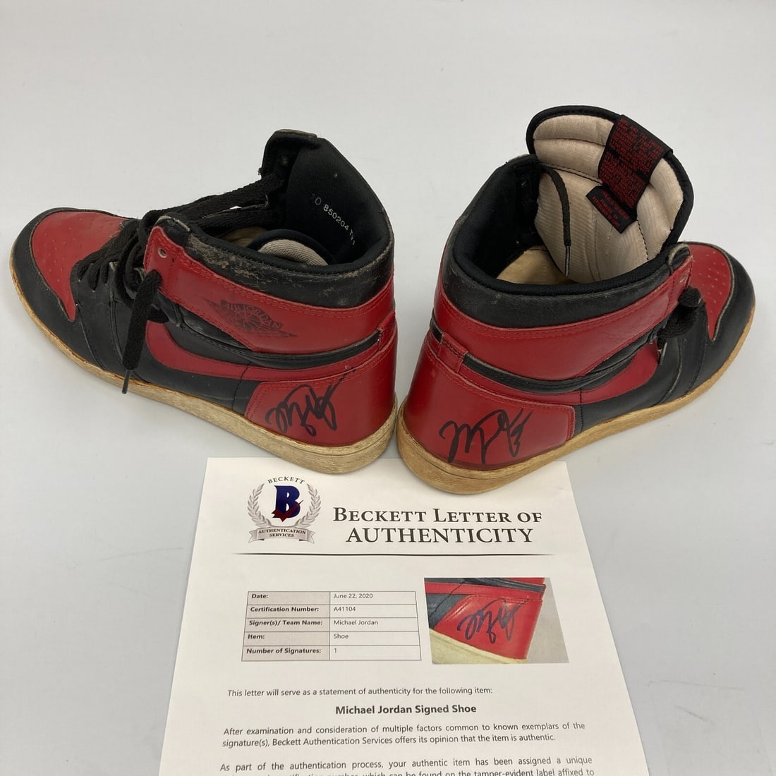 Michael Jordan Signed 1985 Nike Air Jordan 1 Bred Sneakers Beckett Authenticated: Michael Jordan Signed 1985 Nike Air Jordan 1 Bred Sneakers Beckett Authenticated Offered is a remarkable pair of original Nike Air Jordan 1 sneakers, famously known as the "Breds" or "Banned Shoes," s