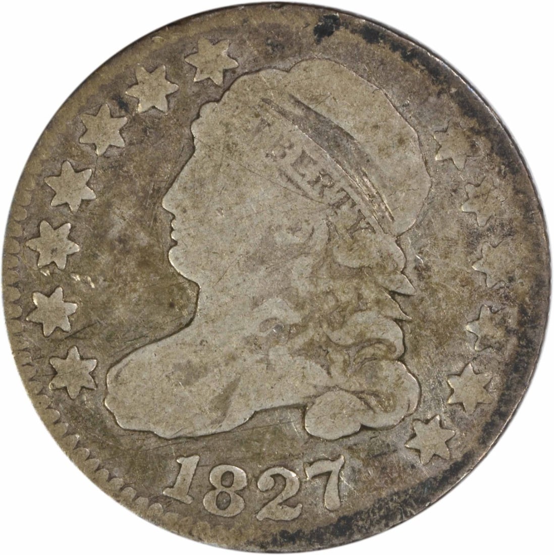 1827 Capped Bust Dime Philadelphia 10C Silver Uncertified Coin: 1827 Capped Bust Dime Philadelphia 10C Silver Uncertified Coin This is an 1827 Capped Bust silver dime from the United States, designed by John Reich and minted in Philadelphia. The coin is circulated