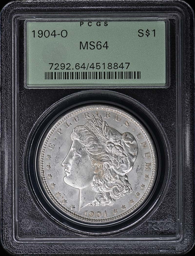 1904-O Morgan Dollar PCGS MS64 New Orleans Mint: 1904-O Morgan Dollar PCGS MS64 New Orleans Mint This is a 1904 Morgan Dollar minted in New Orleans, graded MS64 by PCGS and housed in an Old Green Holder (OGH). The coin is uncirculated and originates